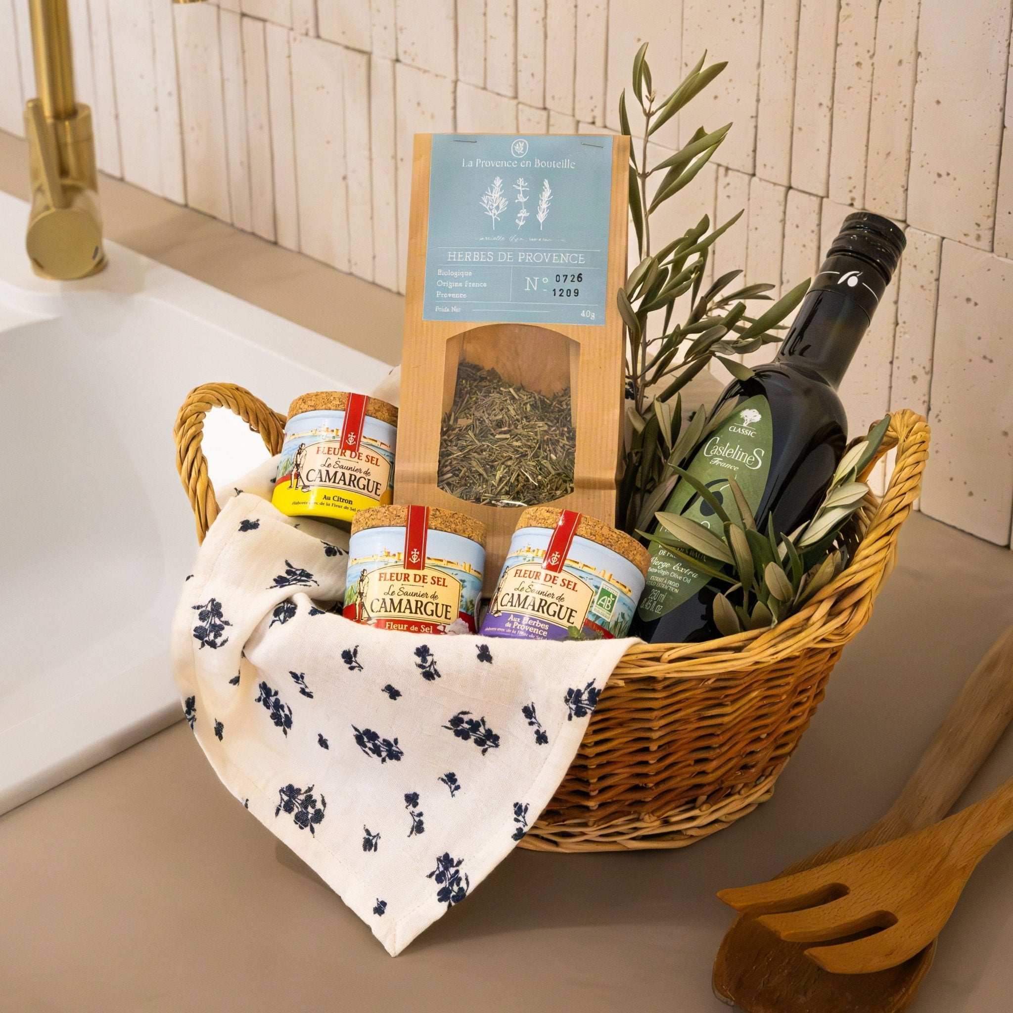 The Condiment Essentials box from Céline en Provence, containing a bottle of olive oil, a jar of Provence herbs, and three pots of Fleur de Sel.