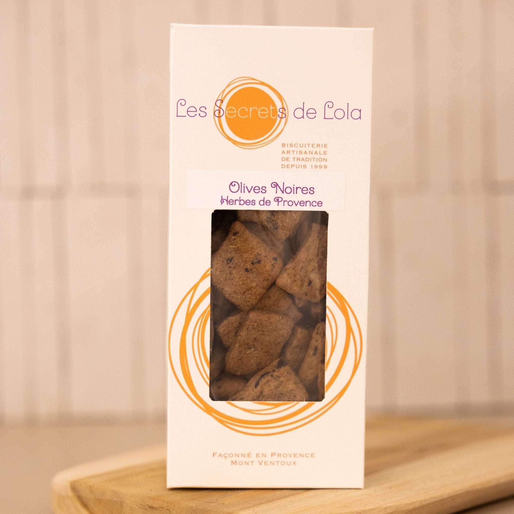 A bowl of savoury biscuits with black olives and Provence herbs, perfect as a snack.