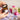 Hands opening Joséphine almond scented candle jar with Provençal soap in background