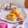 Provençal almond croquants on a plate with whole almonds and almond blossom