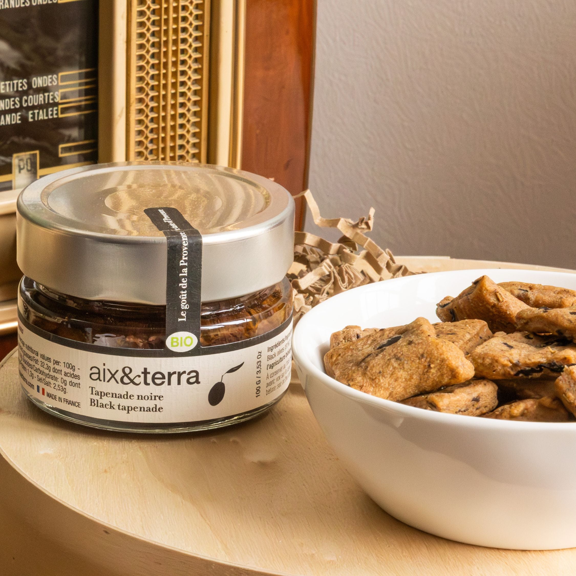 The Apéro Duo from Céline en Provence, a set with a jar of black olive tapenade and a box of savoury olive biscuits, perfect for an aperitif.