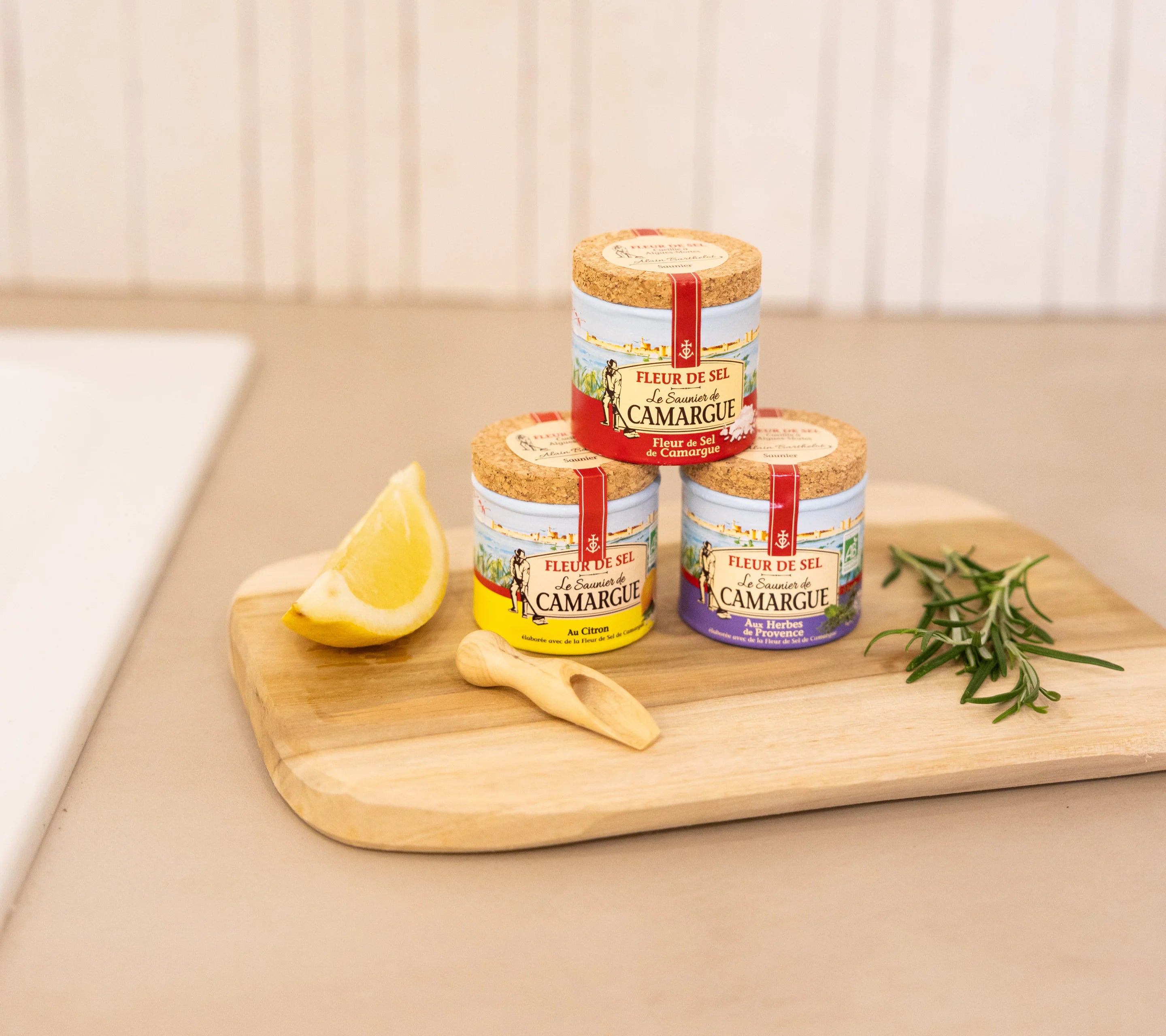 Artisanal wooden salt spoon paired with Fleur de Sel de Camargue trio jars and rosemary, Provençal gourmet gift
