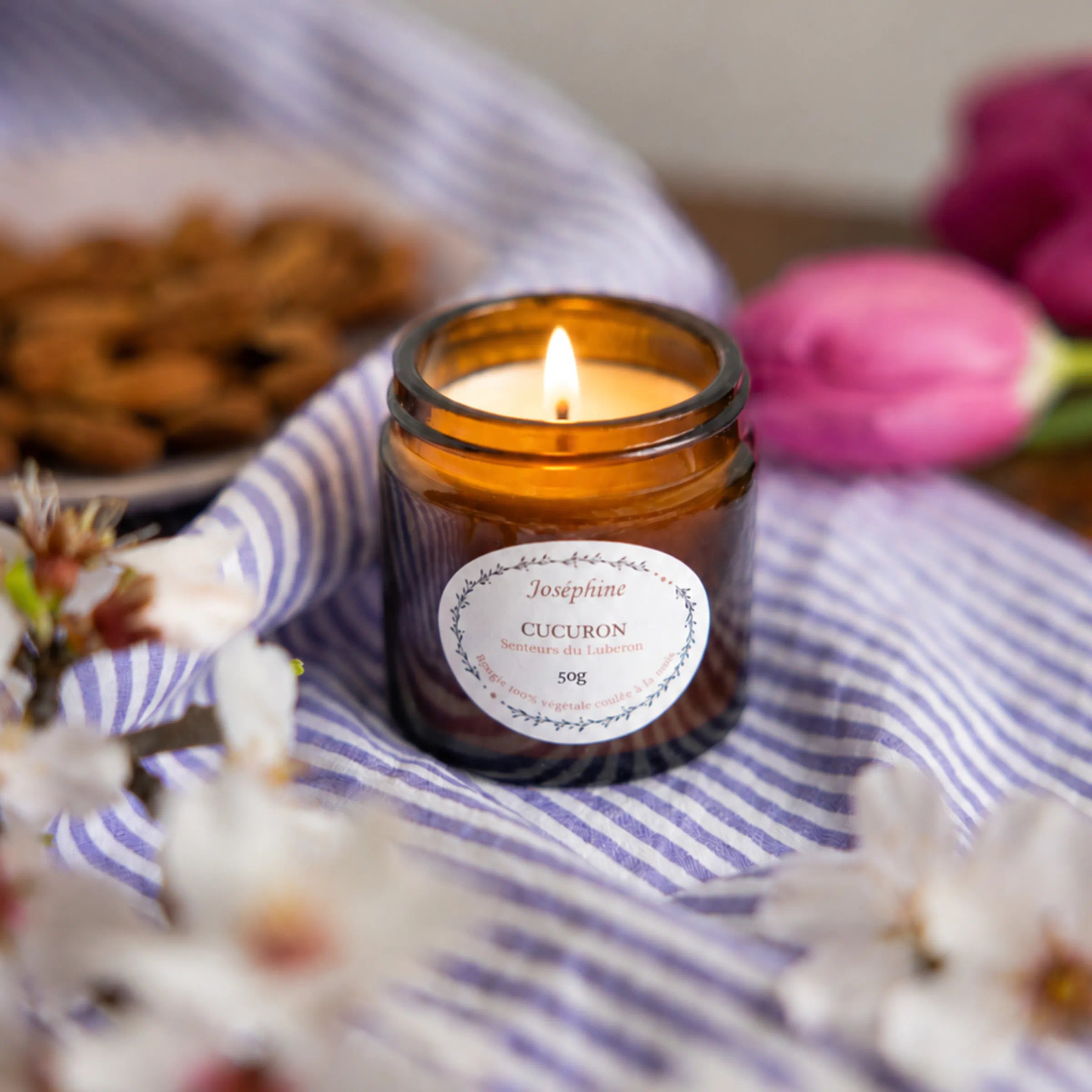 Joséphine Cucuron scented candle lit with almond blossom and tulips, Luberon Provence