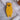 Back view of yellow AnimOC wooden cicada showing gold hanging triangle and engraved logo, Provençal wall art