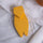 Yellow painted wooden cicada by AnimOC front view on white embroidered fabric, handcrafted Provençal decoration