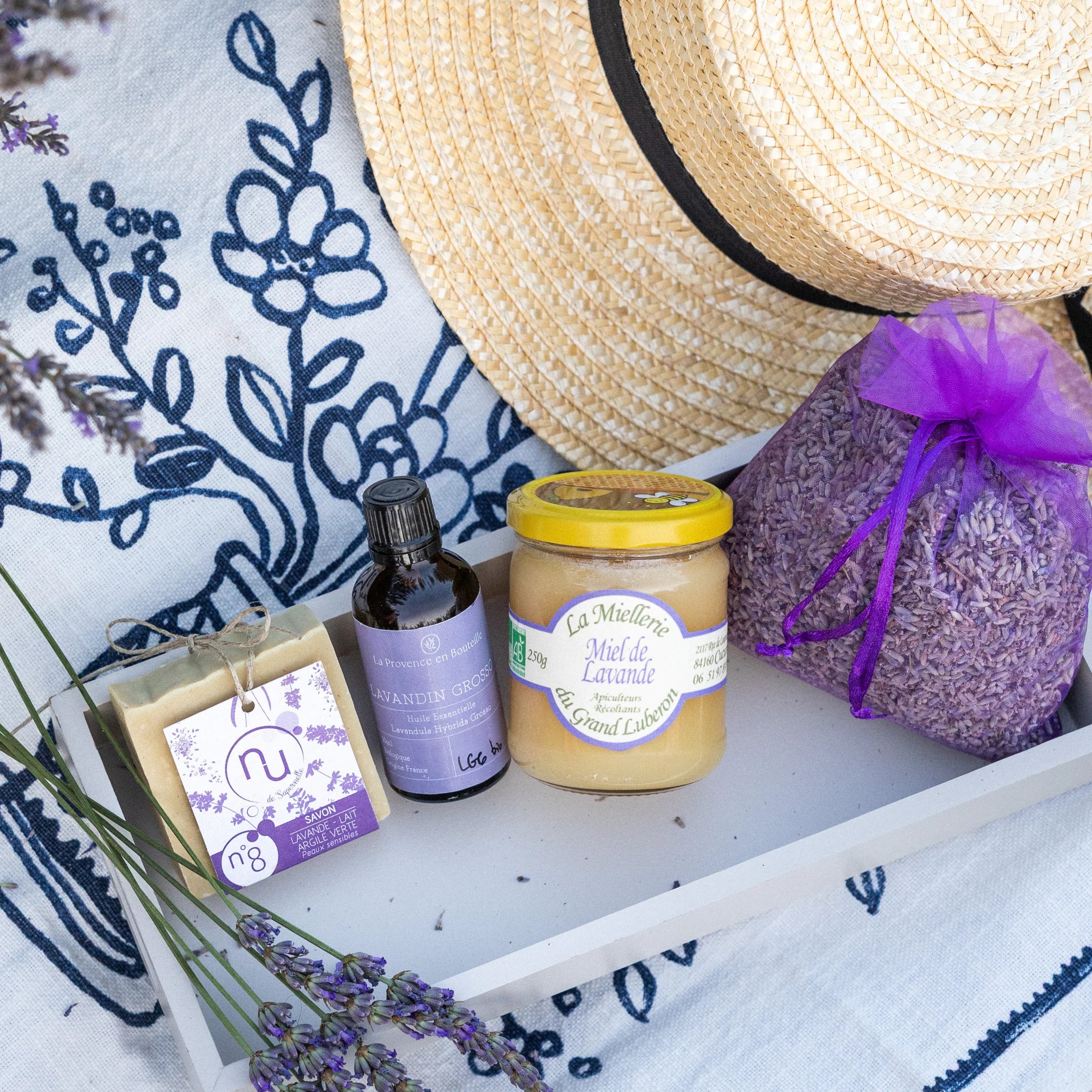 Discover Lavender gift box flat lay with lavender products, straw hat, Provençal fabric and fresh lavender stems, summer Provence