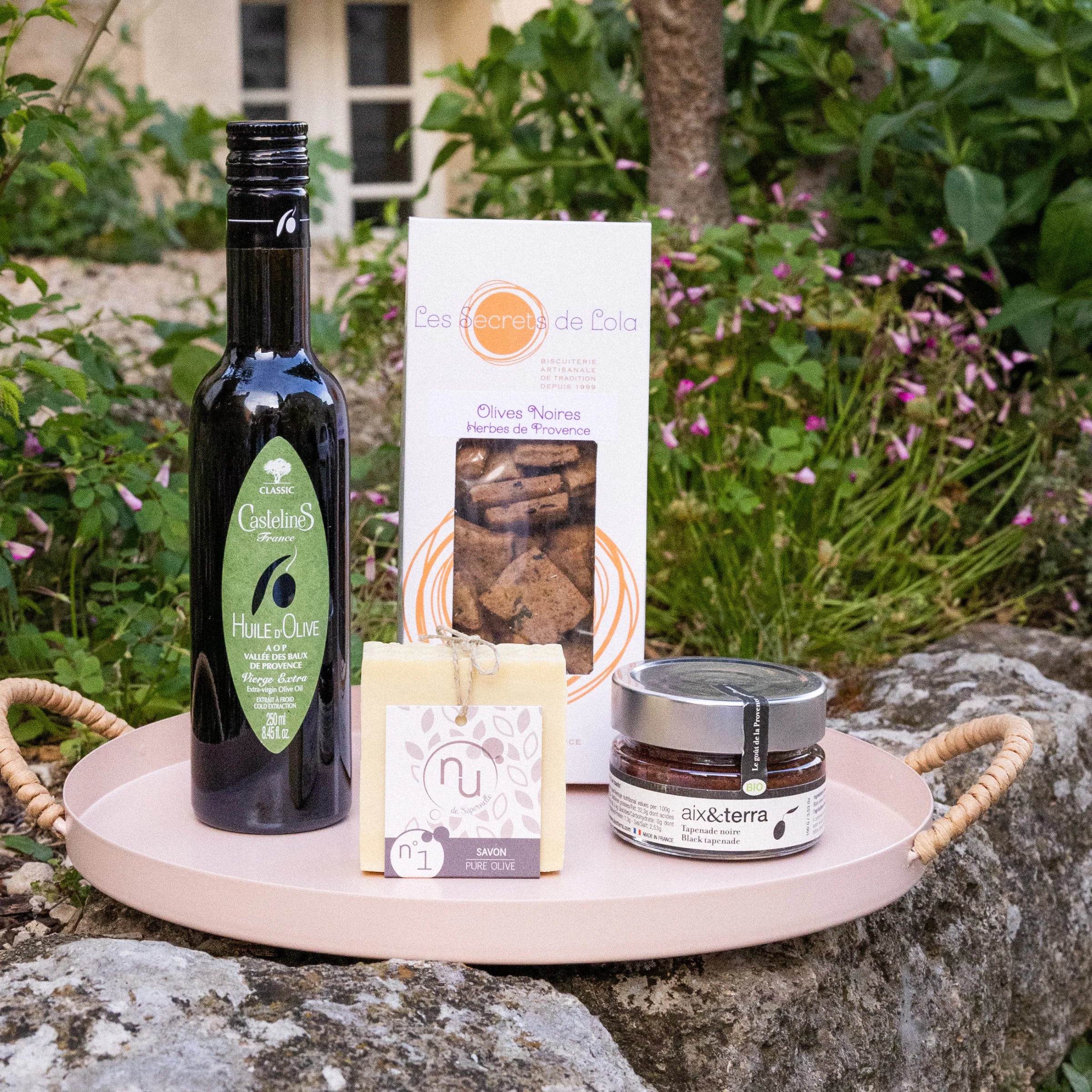 Discover Olives gift box with black olive biscuits, AOP olive oil, organic black tapenade and pure olive soap in a wicker basket with Provençal fabric