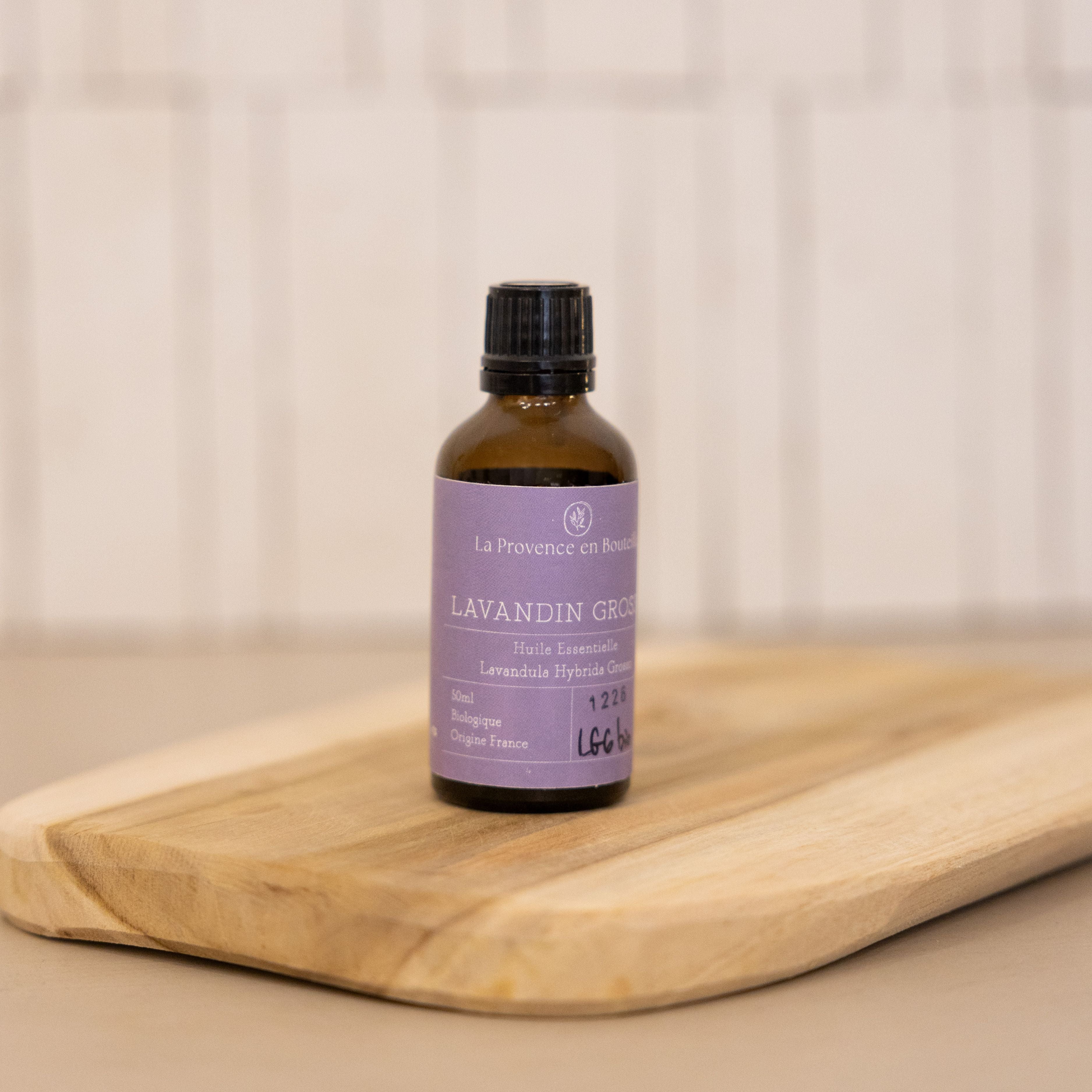 A bottle of organic Lavandin Grosso essential oil from Provence, with a bold and relaxing lavender scent.
