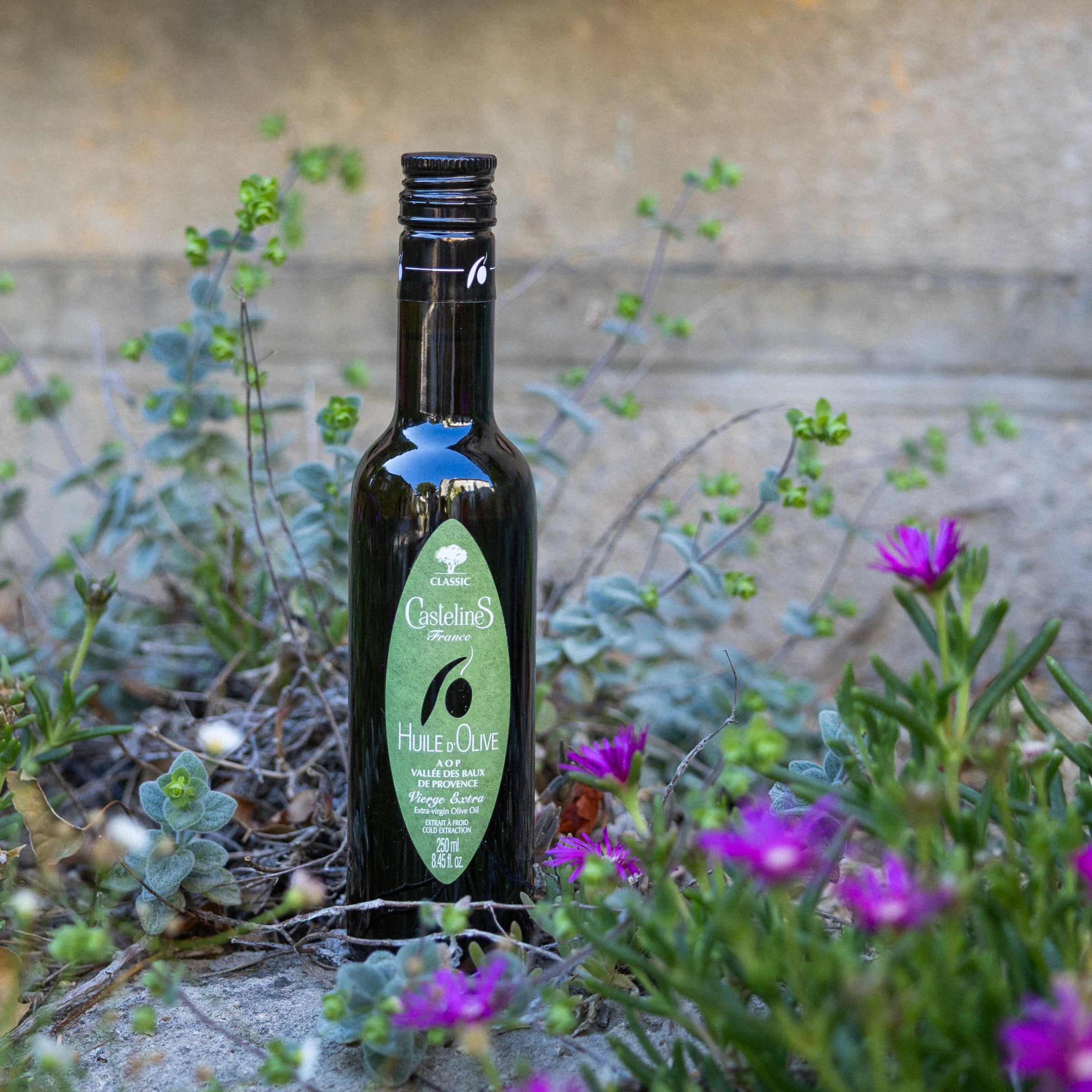 Pouring Castelines AOP extra virgin olive oil from Provence into a small ceramic bowl