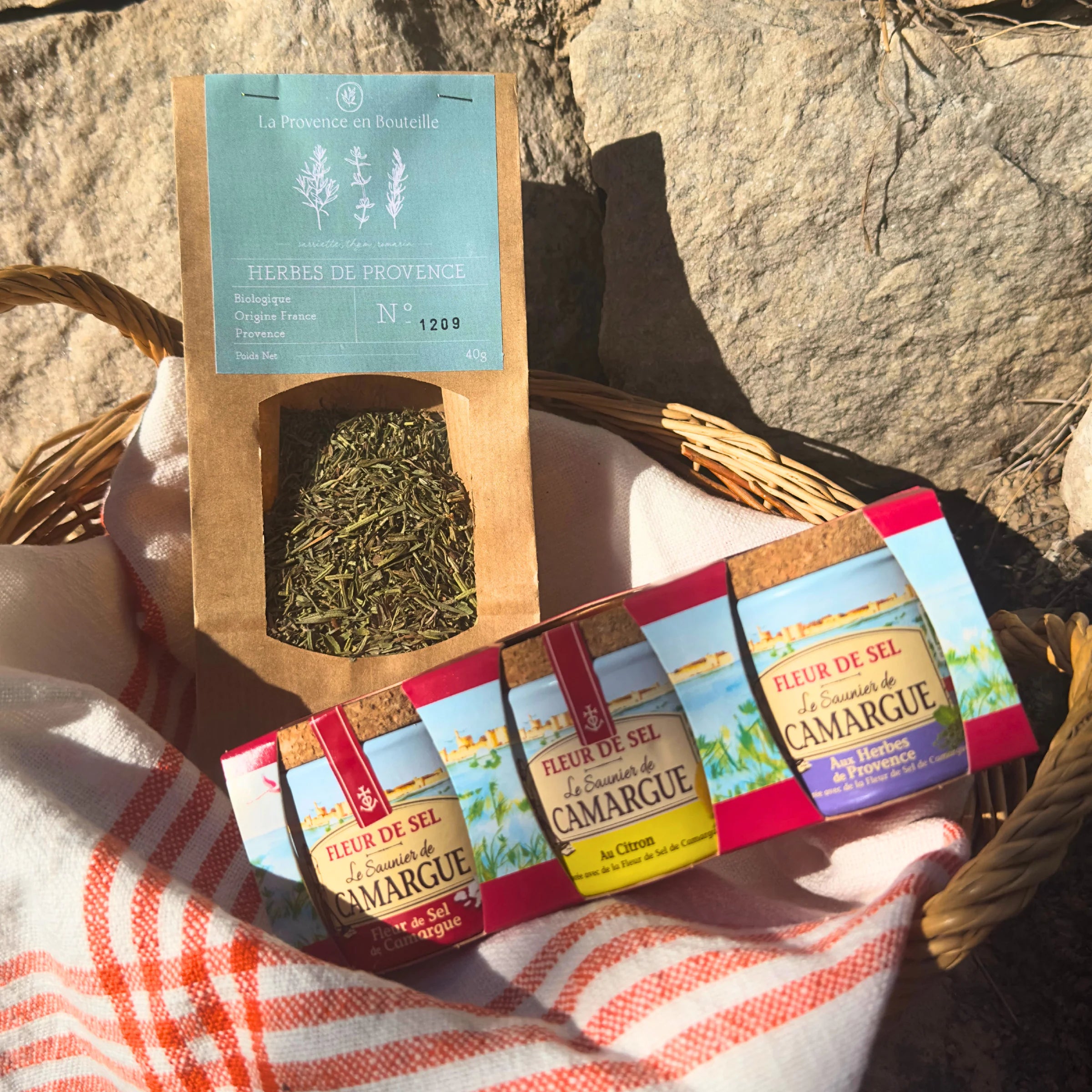 Gourmet Seasoning Duo with organic Provence herbs and Fleur de Sel de Camargue trio in a wicker basket on Provençal stone