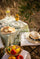 A moment of serenity, a taste of Provence, Provençal outdoor table under olive trees with lemon olive oil, bread and colourful tomatoes, golden summer light