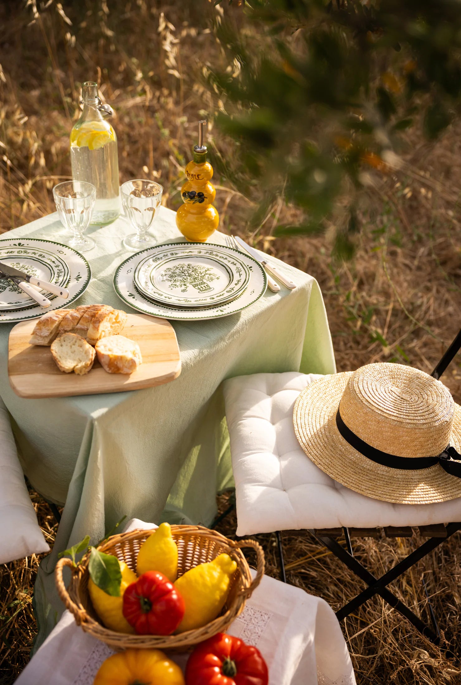 Summer Collection banner, Provençal table set outdoors under olive trees with olive oil and seasonal produce, summer in Provence