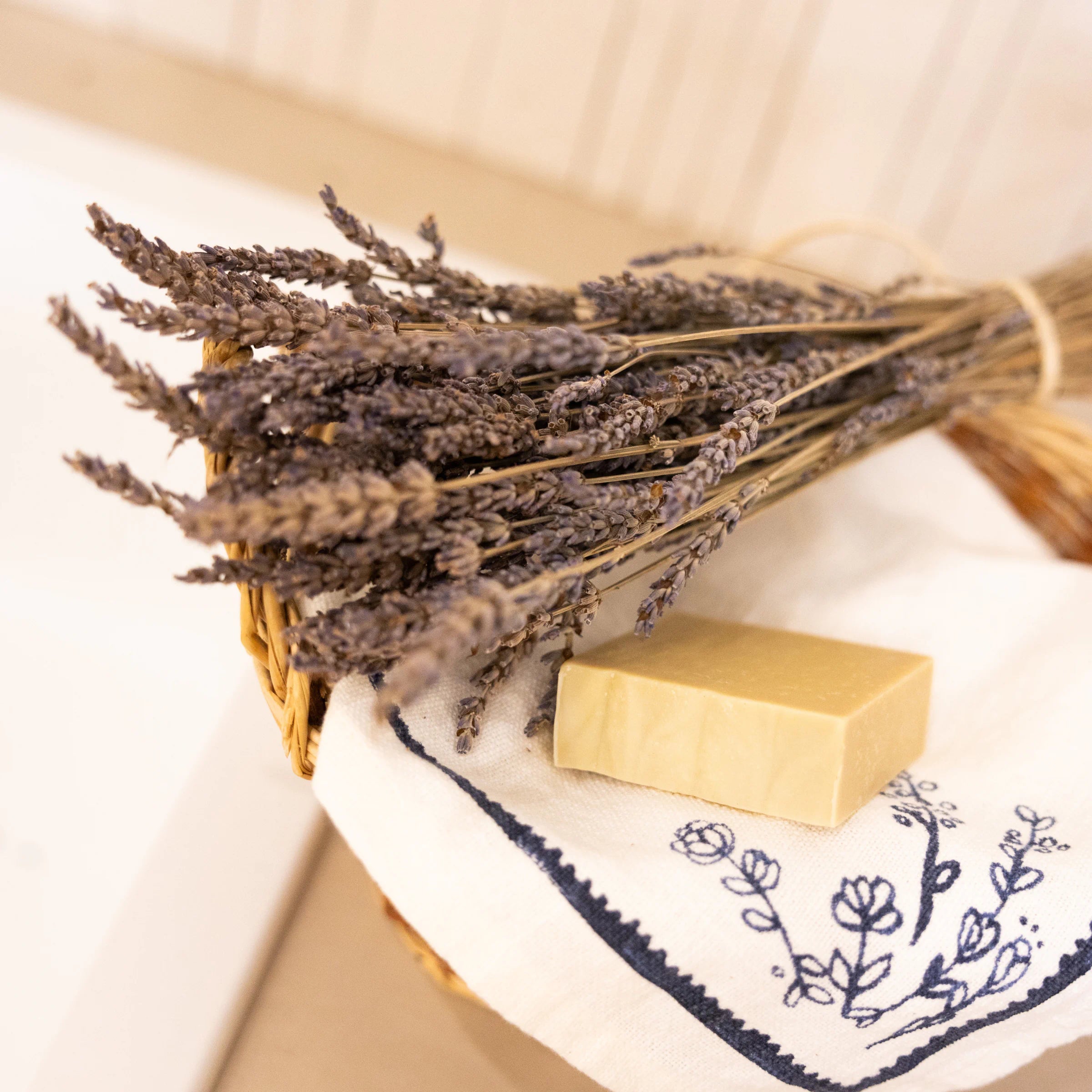 Natural lavender soap bar with dried lavender bunch and wicker basket, Provençal home ritual