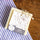 Nu de Sapernelle N°1 pure olive soap bar on wood with Provençal striped fabric