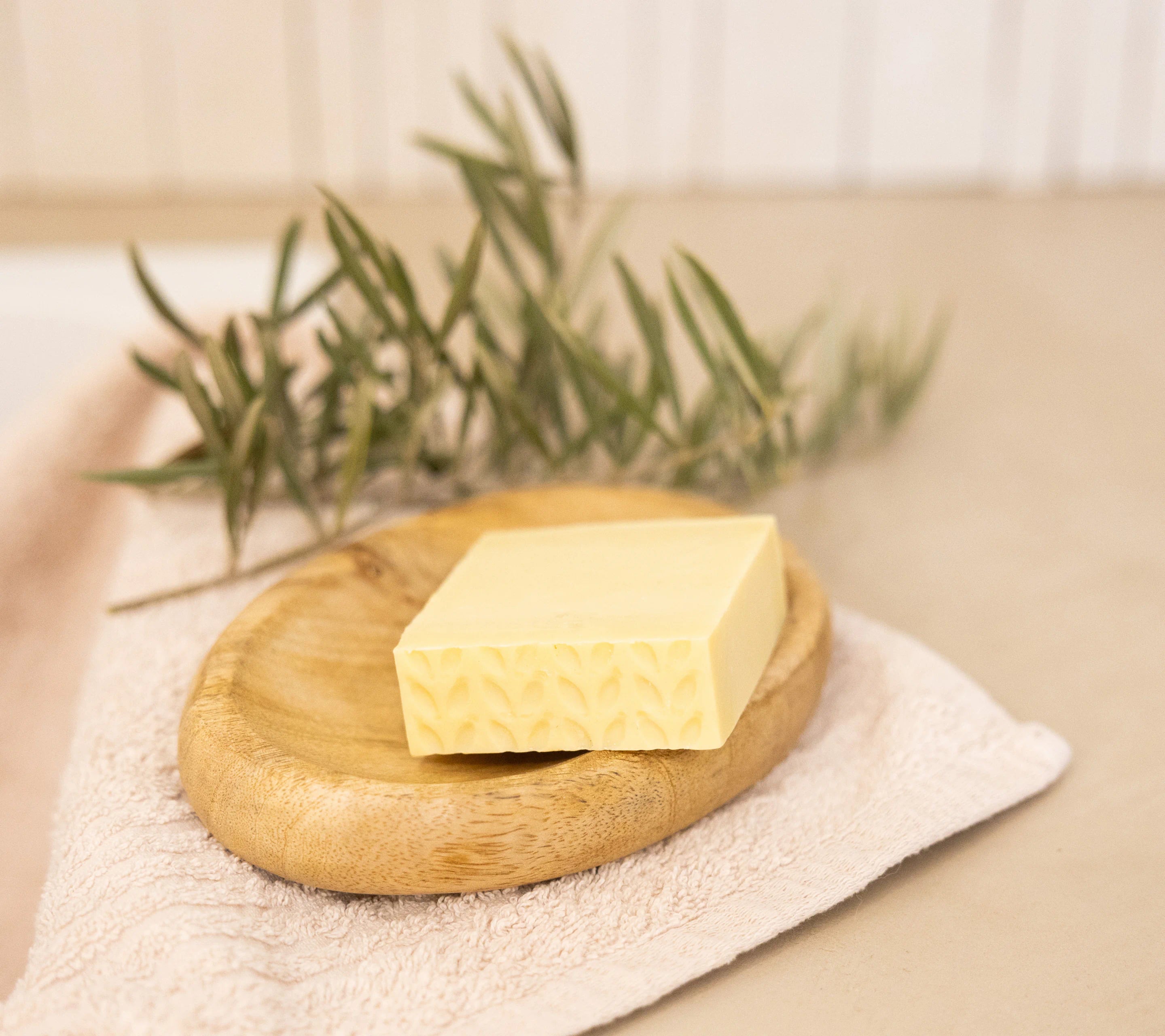 Nu de Sapernelle pure olive soap bar on a wooden tray with fresh rosemary, Provençal skincare ritual
