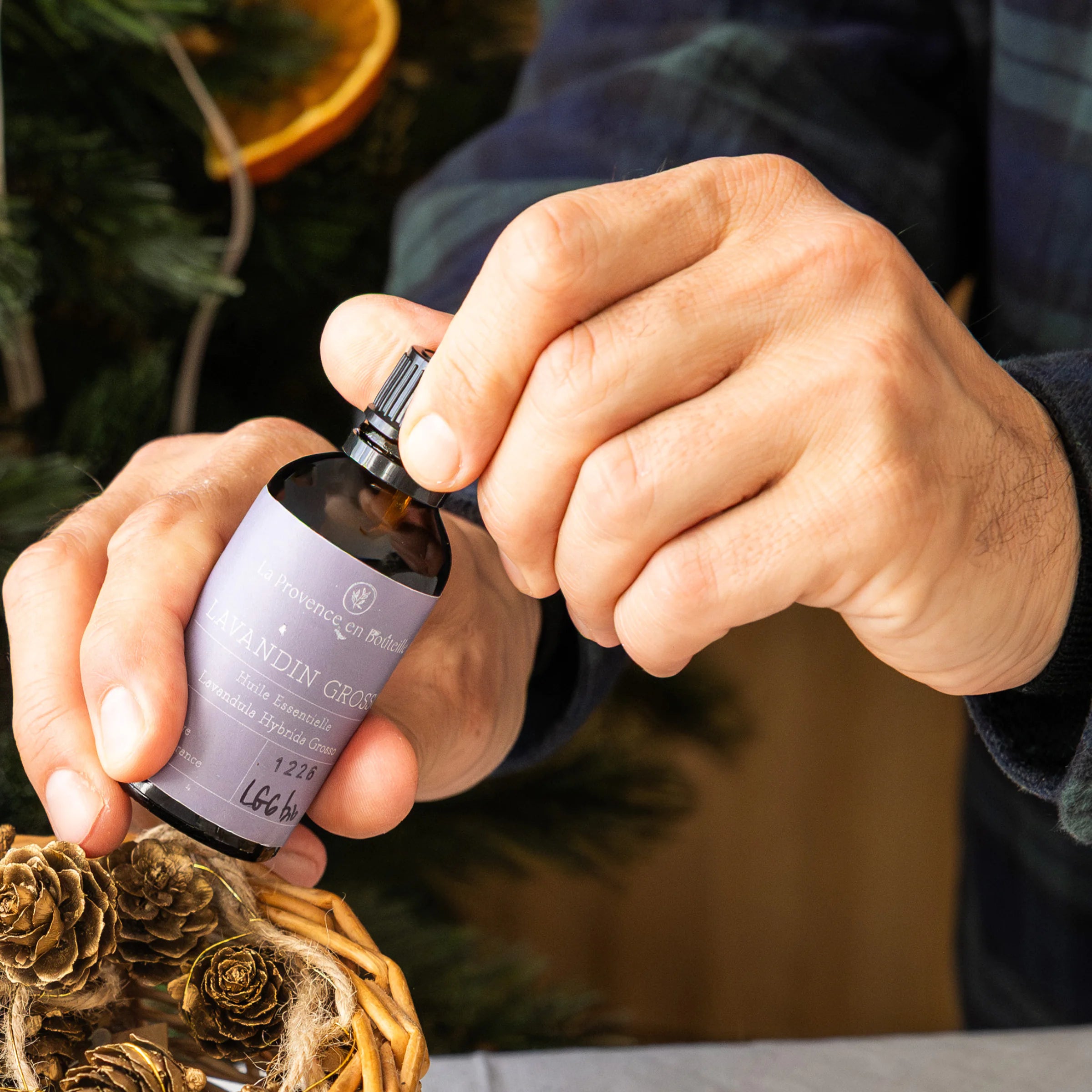 La Provence en Bouteille organic Lavandin Grosso essential oil 50ml bottle on stone wall, Provence