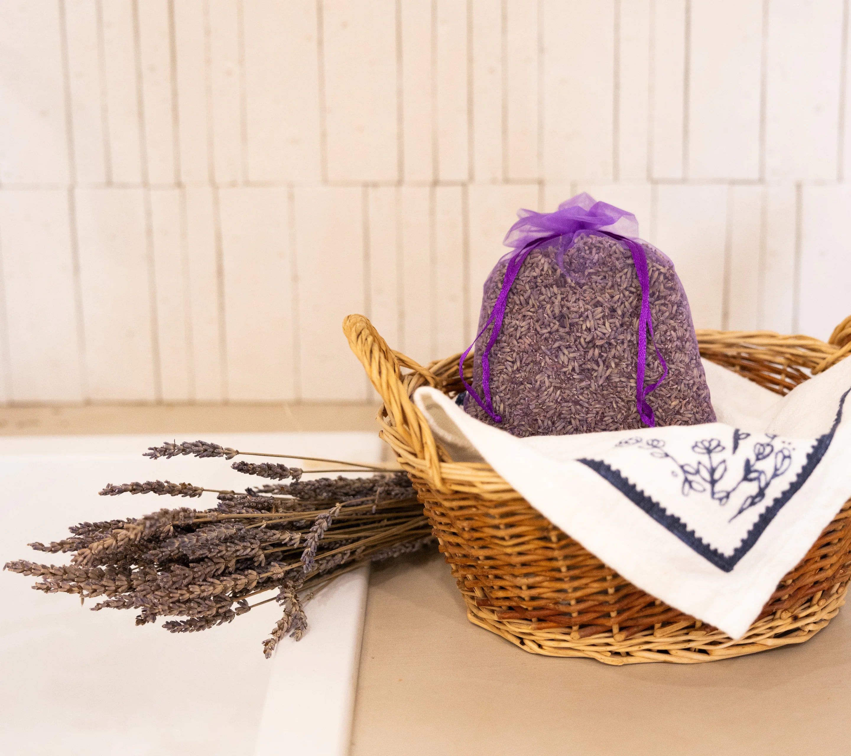 Organic Lavandin Grosso essential oil paired with lavender pouch in a wicker basket for a calming Provençal ritual
