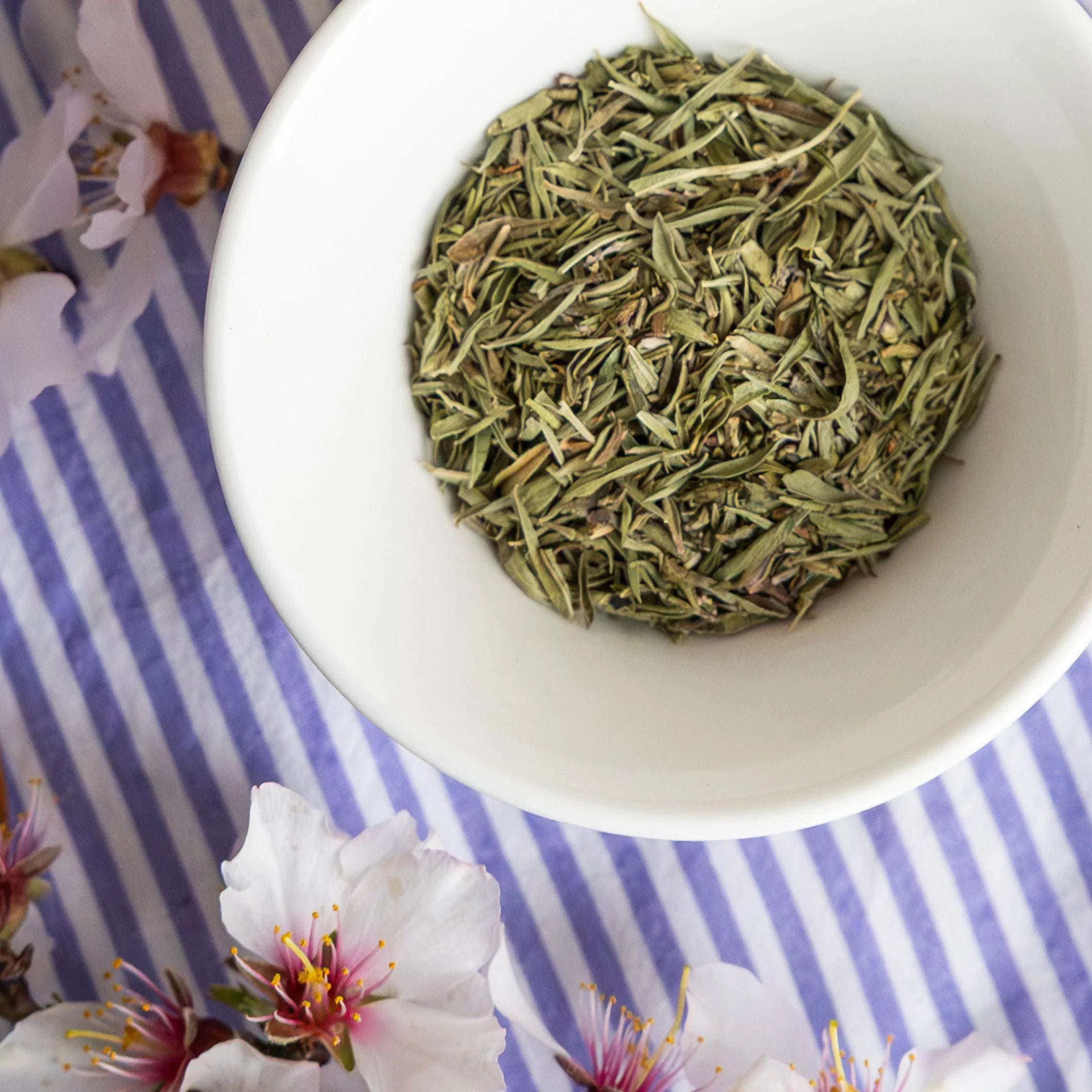 A gourmet spring gift box featuring a 250g jar of organic lavender honey, 200g of almonds croquants, and organic Provence herbs by Céline en Provence.