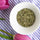 Overhead view of organic dried Provence herbs in a white bowl with pink tulips