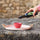A close-up of a rustic Provençal seasoning ritual, featuring a drizzle of AOP extra virgin olive oil over fresh bread, alongside authentic French Fleur de Sel and organic Herbes de Provence, representing Céline en Provence.
