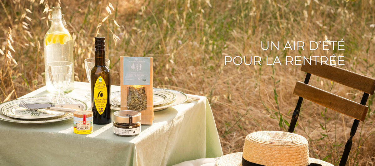 Un air d'été pour la rentrée, table provençale en plein air avec huile d'olive citron, herbes de Provence, Fleur de Sel et tapenade, collection été