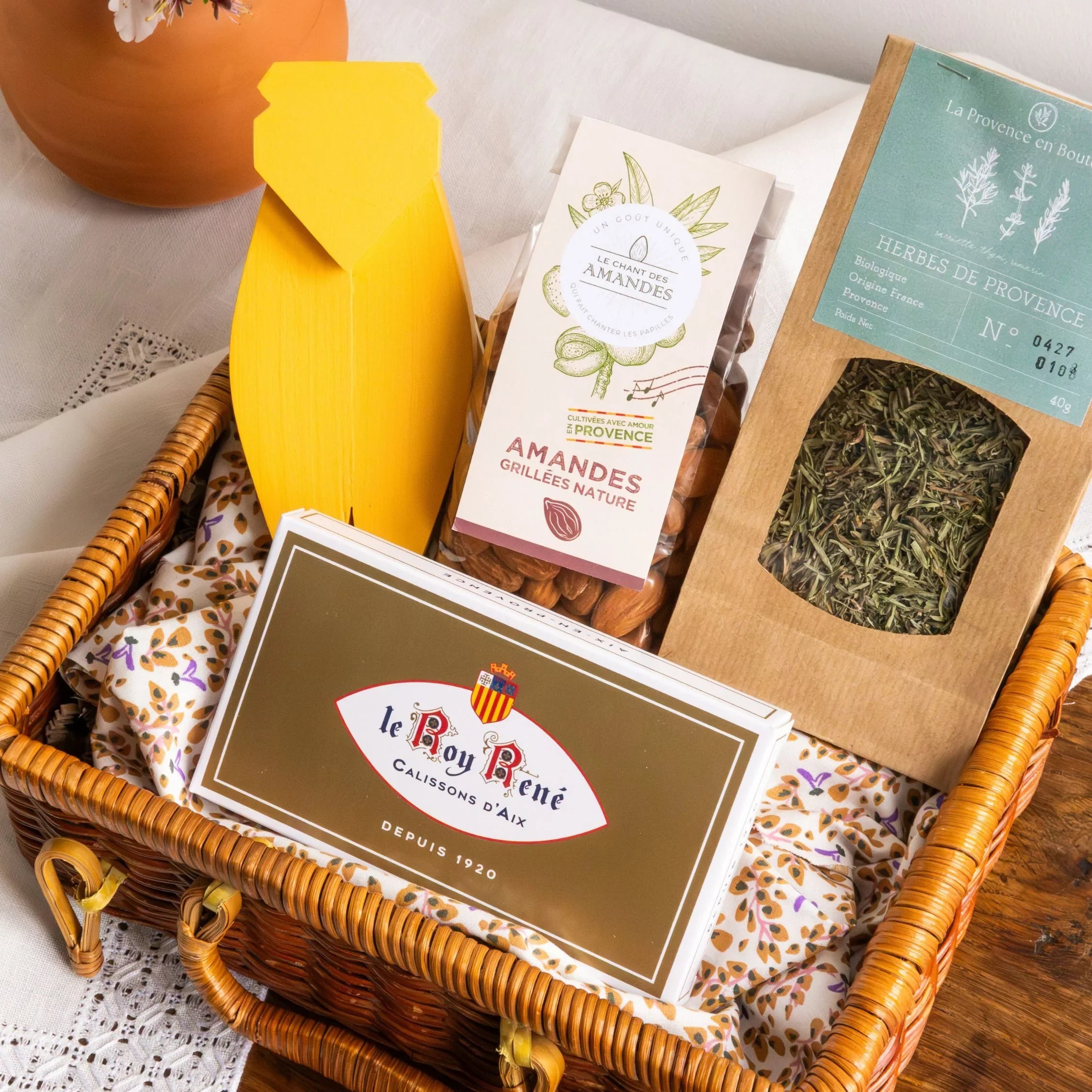 A close-up of the yellow decorative wooden cicada, a handcrafted symbol of good luck and Provençal craftsmanship, included in the Icon of Provence box.