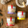 Overhead view of Trio Fleur de Sel de Camargue jars on wood with wooden salt spoon and olive branch